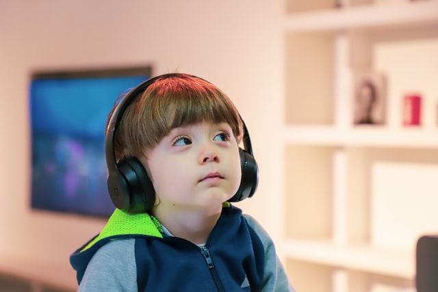 Small child with headphones on
